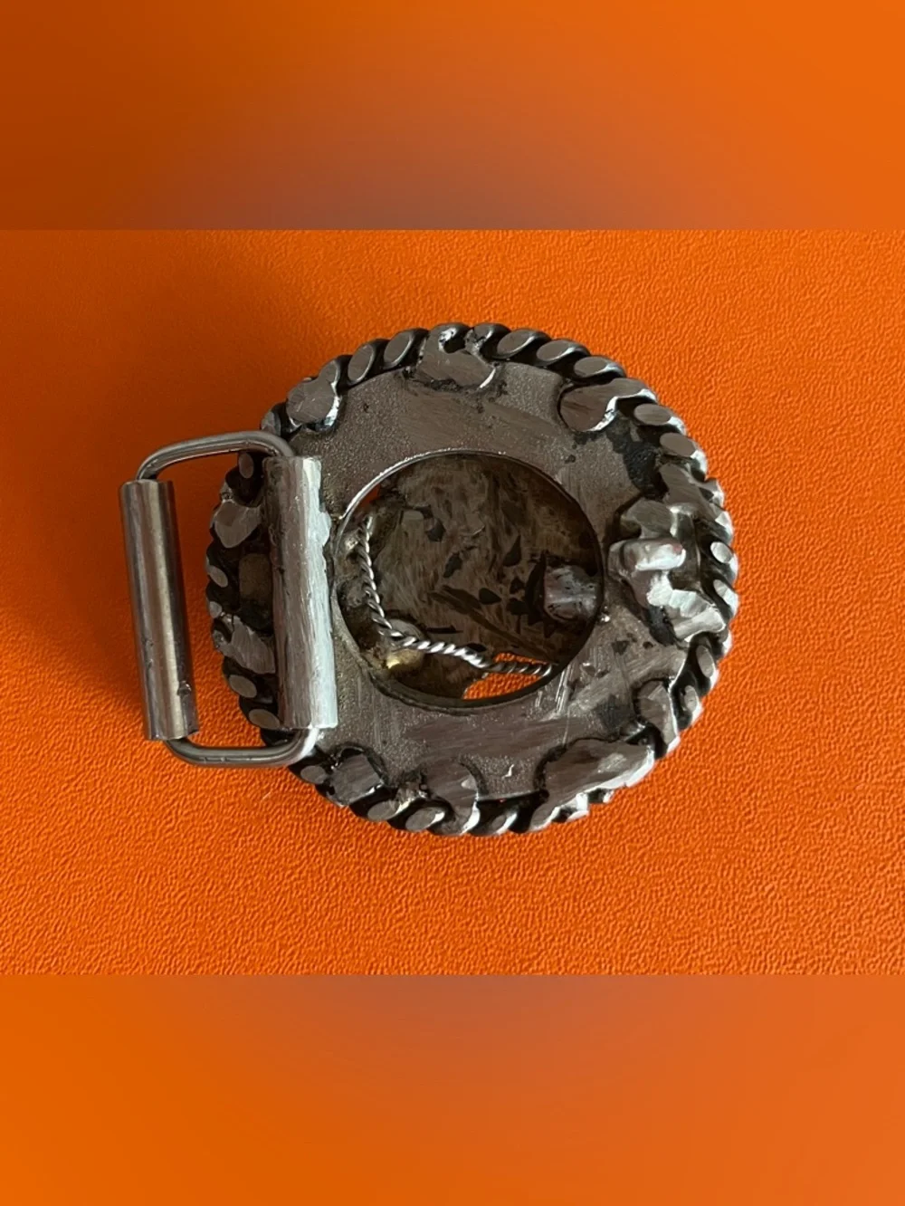 Vintage western-style belt buckle features a sculpted horse head,